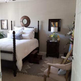 A cozy and elegantly decorated bedroom featuring a four-poster bed, soft bedding, and stylish decor.