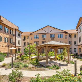 A residential building with a landscaped courtyard featuring a central gazebo.
