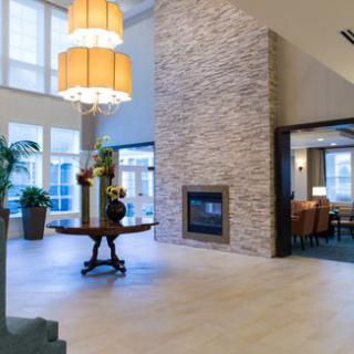 A modern lobby area featuring a fireplace and elegant decor.