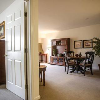 A cozy living room with a dining area and classic decor.