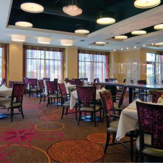An elegant restaurant interior with neatly arranged tables and chairs.