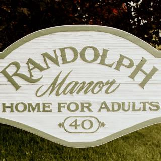 A sign for Randolph Manor, a home for adults.