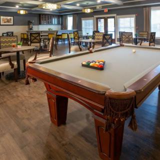 A cozy game room featuring a pool table and seating area.