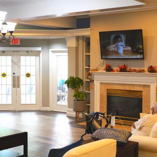 A cozy living room with a fireplace, sofa, and television.