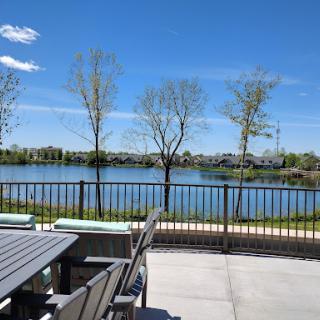 A peaceful lakeside view featuring trees and a clear blue sky, perfect for relaxation.