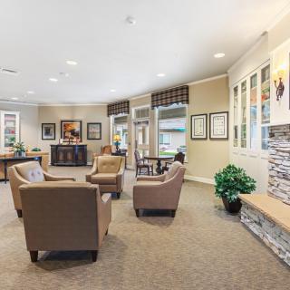 A cozy and well-decorated waiting area with comfortable seating and artwork.