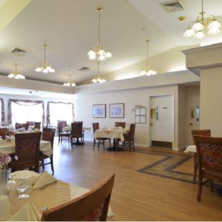A spacious and elegantly decorated dining area with neatly arranged tables and chairs.