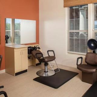 A modern hair salon interior with styling chairs and mirrors.