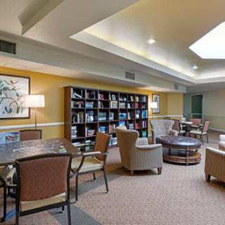A cozy library reading area with comfortable seating and bookshelves.
