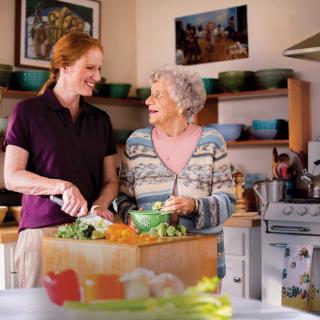 Two people enjoying cooking together in the kitchen.