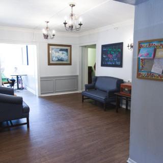 A well-lit waiting room with comfortable seating and elegant decor.