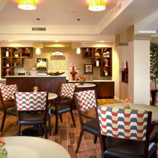 A cozy restaurant dining area with patterned chairs and ambient lighting.