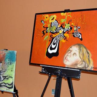 A vibrant painting featuring abstract shapes and a child's portrait, displayed on an easel.