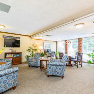 A cozy lounge area with comfortable seating and abundant natural light.