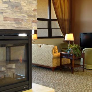 Cozy living room with a fireplace, sofas, and a television.