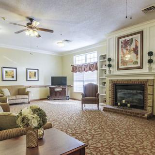 A cozy living room features a fireplace, television, and comfortable seating arrangements.