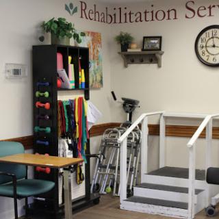 A rehabilitation service room equipped with exercise tools and a set of steps for patient training.