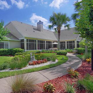 A beautiful residential home with a well-maintained garden and curved pathway.