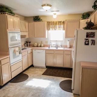 A cozy kitchen with wooden cabinets and modern appliances.