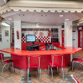 A retro-themed diner with red seating and checkered walls.
