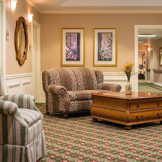A cozy seating area in a well-decorated interior space featuring comfortable sofas and elegant decor.