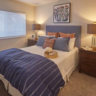 Cozy bedroom with modern decor and soft lighting.