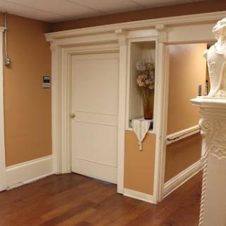 A well-decorated hallway featuring a closed door and elegant design elements.