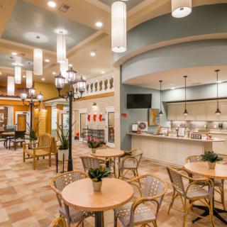 A cozy and inviting cafe interior with elegant lighting and comfortable seating.