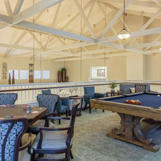 A spacious game room featuring a billiards table and comfortable seating for relaxation and entertainment.