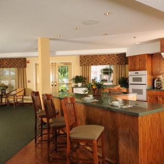 A modern kitchen with bar seating and open layout.