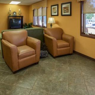 A cozy waiting room with comfortable chairs and a television.