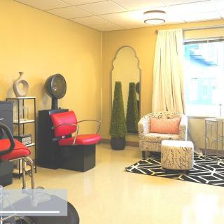 A bright and modern salon interior with a hair dryer station and stylish decor.