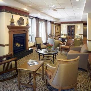 A cozy living room with a fireplace and comfortable seating.