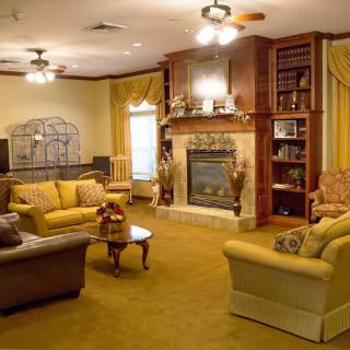 A warm and inviting living room featuring a fireplace, comfortable seating, and classic decor.