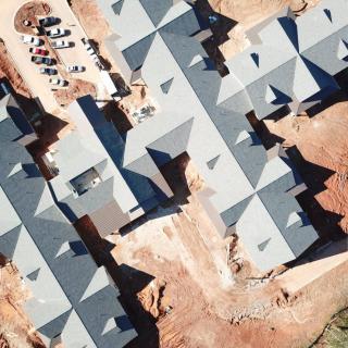 Aerial view of a housing development under construction, showcasing the rooftops and layout.