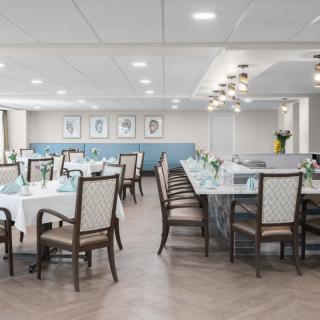 A modern and elegantly designed dining room with neatly arranged tables and chairs.