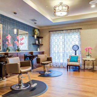 A modern salon interior with stylish chairs, mirrors, and elegant decor.