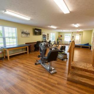 A bright and spacious exercise room equipped with various fitness machines.