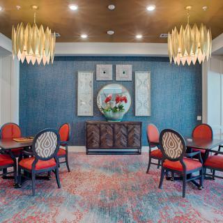 An elegantly designed dining area with ornate chandeliers and vintage-style decor.
