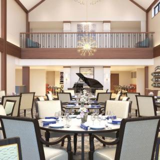 An elegant dining area with a grand piano and well-arranged tables and chairs.