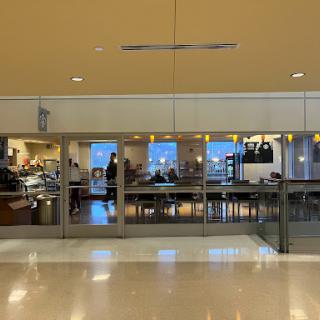 A view of the dining area inside an airport, showcasing various food options.