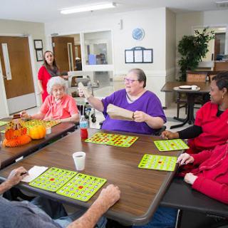 Residents and staff enjoying a lively game of bingo in a community center.