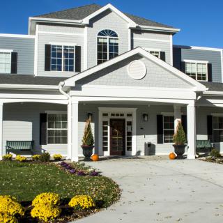 A two-story house with a well-maintained front entrance and landscaping.