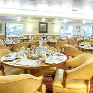An elegant dining room with neatly arranged tables and comfortable chairs.