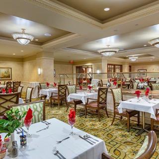 An elegantly decorated restaurant dining room with neatly arranged tables and chairs.
