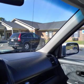 A parked SUV in a parking lot next to a building.