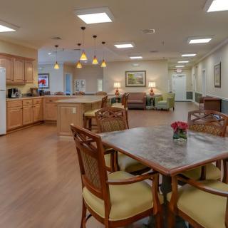 A spacious and well-lit open-concept dining and kitchen area with comfortable seating.