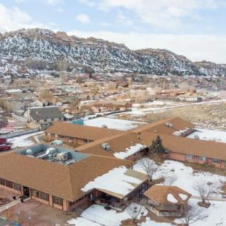 Aerial view of a snow-covered town surrounded by mountainous terrain.