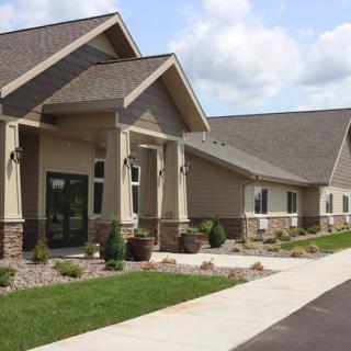 A modern residential building with well-maintained landscaping and a sidewalk.