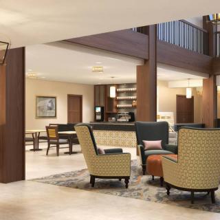 A modern hotel lobby with a seating area and contemporary furniture.
